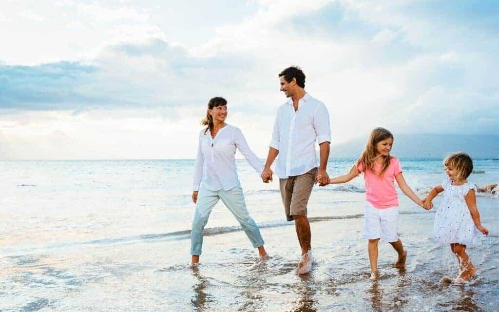 A happy family walking on atlantic beach