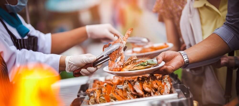 A person serving seafood at the annual festival in Morehead city.